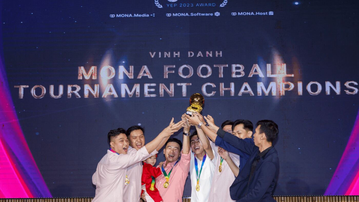 Đội bóng MONA nâng cúp vàng vô địch trên sân khấu tiệc tất niên